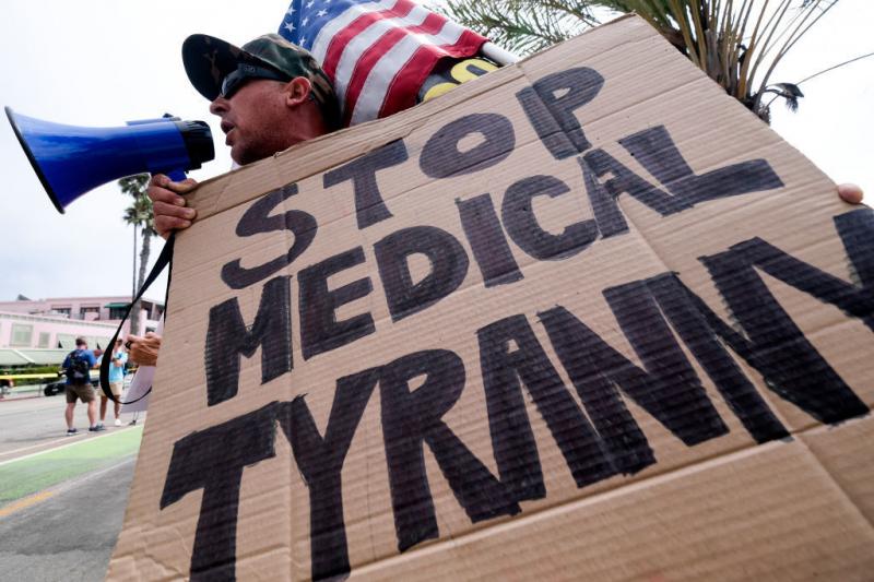 People opposed to COVID-19 vaccines often embrace ivermectin, a drug that's been touted as an effective prevention and treatment for COVID-19, which they think is not getting the attention it deserves. Here, an anti-vaccination protester takes part in a r People opposed to COVID-19 vaccines often embrace ivermectin, a drug that's been touted as an effective prevention and treatment for COVID-19, which they think is not getting the attention it deserves. Here, an anti-vaccination protester takes part in a r