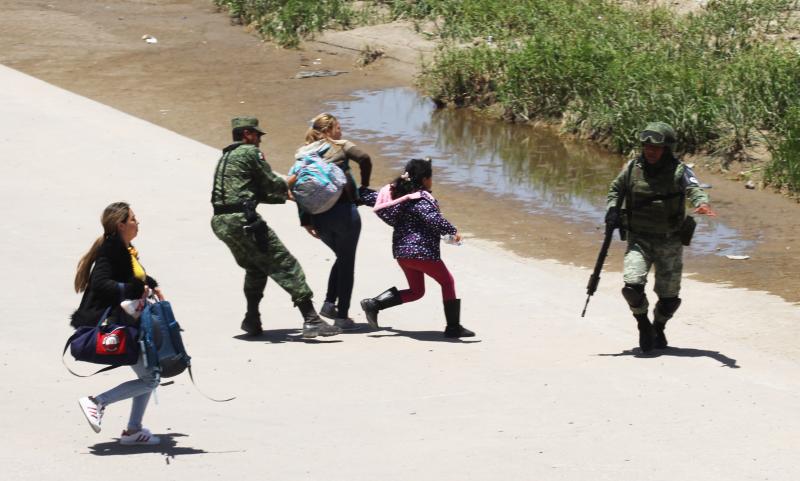 Mexican National Guard members prevent Central American migrants from trying to cross the Rio Grande from Juárez, Mexico, on June 21. Mexican National Guard members prevent Central American migrants from trying to cross the Rio Grande from Juárez, Mexico, on June 21.