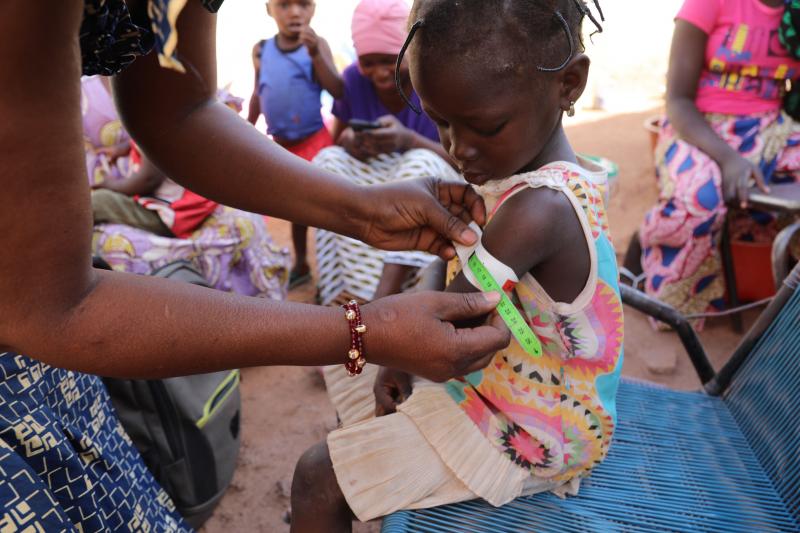 Nana Kadidia Diawara, a nurse who is a community health worker in Mali's capital city of Bamako, measures the arm of a child to check for signs of malnutrition. There's no charge for the care she provides. Nana Kadidia Diawara, a nurse who is a community health worker in Mali's capital city of Bamako, measures the arm of a child to check for signs of malnutrition. There's no charge for the care she provides.