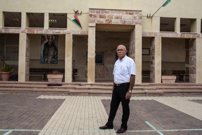 Principal Ali Shalalha stands at the entrance of the high school. Though the school has closed for summer, it's filled with students who are studying for exams. Principal Ali Shalalha stands at the entrance of the high school. Though the school has closed for summer, it's filled with students who are studying for exams.