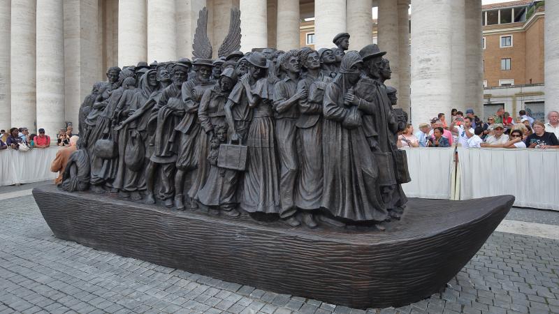 The 20-foot-tall bronze sculpture of a boat loaded with refugees and migrants is the work of Canadian sculptor Timothy Schmalz. Its bread-and-fruit motif encapsulates how food is interlocked with the history of human migration. The 20-foot-tall bronze sculpture of a boat loaded with refugees and migrants is the work of Canadian sculptor Timothy Schmalz. Its bread-and-fruit motif encapsulates how food is interlocked with the history of human migration.
