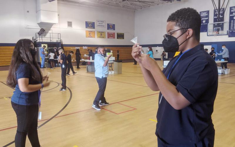Julian Hernandez (right), 12, a seventh-grader at Hillside School in Illinois, says he feels much safer being back in school knowing that a weekly testing program is identifying those who are sick with COVID-19. Julian Hernandez (right), 12, a seventh-grader at Hillside School in Illinois, says he feels much safer being back in school knowing that a weekly testing program is identifying those who are sick with COVID-19.