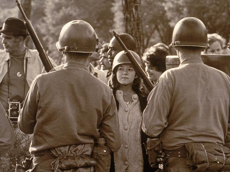 A young female protester faces down armed police officers at an anti-Vietnam War demonstration outside the 1968 Democratic National Convention in Chicago. A young female protester faces down armed police officers at an anti-Vietnam War demonstration outside the 1968 Democratic National Convention in Chicago.