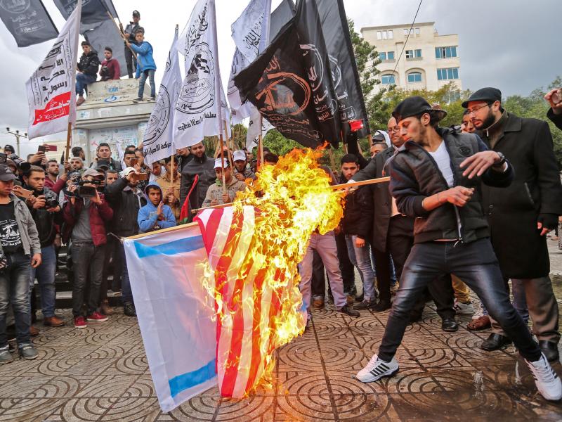 Palestinian protesters burn U.S. and Israeli flags in Gaza City on Wednesday. President Trump has recognized Jerusalem as Israel's capital, upending decades of U.S. policy and ignoring dire warnings from allies. Palestinian protesters burn U.S. and Israeli flags in Gaza City on Wednesday. President Trump has recognized Jerusalem as Israel's capital, upending decades of U.S. policy and ignoring dire warnings from allies.