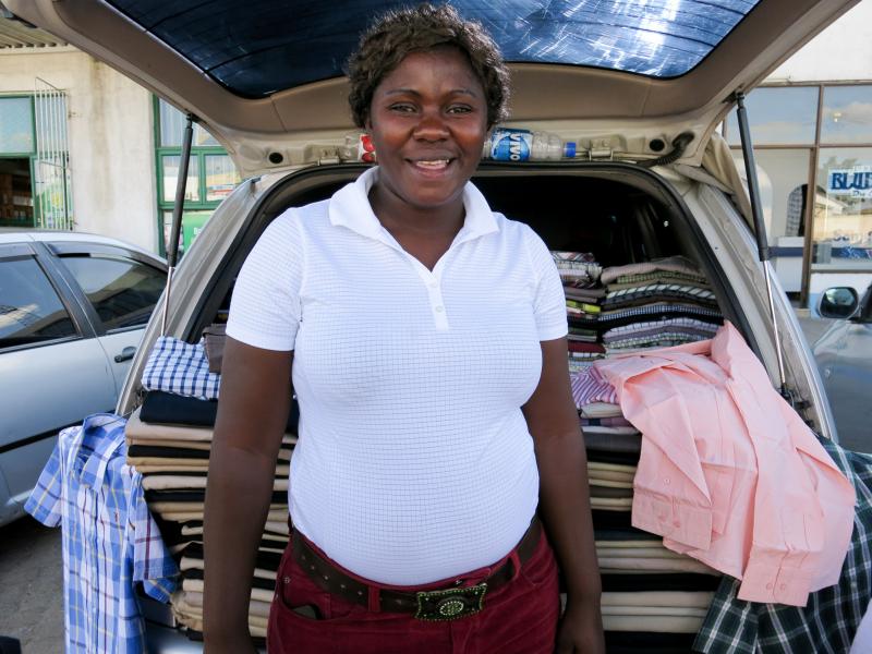 Fortunate Nyakupinda earns a living by selling secondhand clothes from the back of her car. Fortunate Nyakupinda earns a living by selling secondhand clothes from the back of her car.
