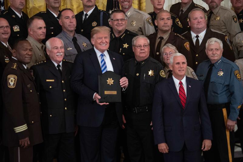 President Trump, with Vice President Pence, poses with a plaque given to him by sheriffs from across the country during a meeting in September. Trump has campaigned as a strong advocate for law enforcement. President Trump, with Vice President Pence, poses with a plaque given to him by sheriffs from across the country during a meeting in September. Trump has campaigned as a strong advocate for law enforcement.