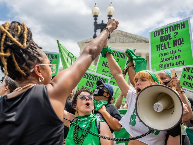 Abortion rights activists clad in green and carrying green signs protest outside the Supreme Court on Saturday. Abortion rights activists clad in green and carrying green signs protest outside the Supreme Court on Saturday.