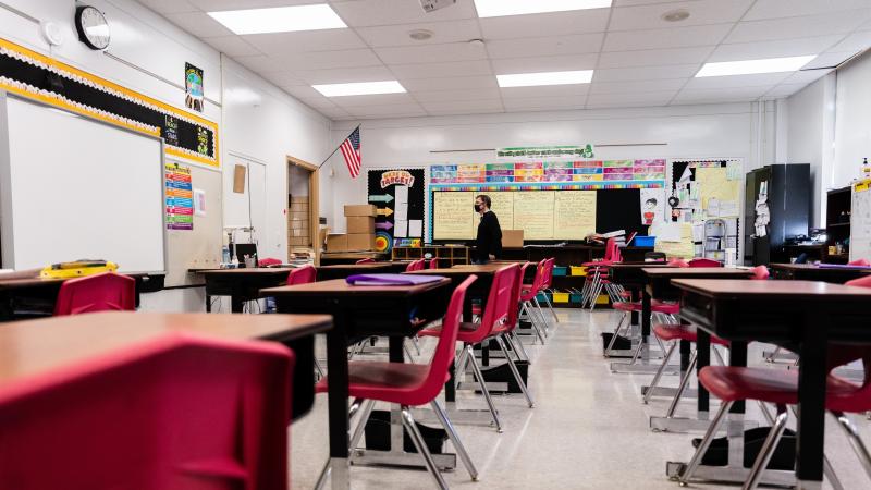 A teacher walks through an empty classroom at Hazelwood Elementary School in Louisville, Ky., on Jan. 11. A teacher walks through an empty classroom at Hazelwood Elementary School in Louisville, Ky., on Jan. 11.