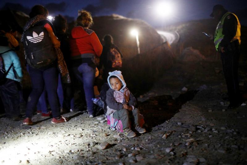 A group of Honduran migrants are detained along the U.S.-Mexico border by Mexican police after attempting to cross the border barrier into the U.S. A group of Honduran migrants are detained along the U.S.-Mexico border by Mexican police after attempting to cross the border barrier into the U.S.