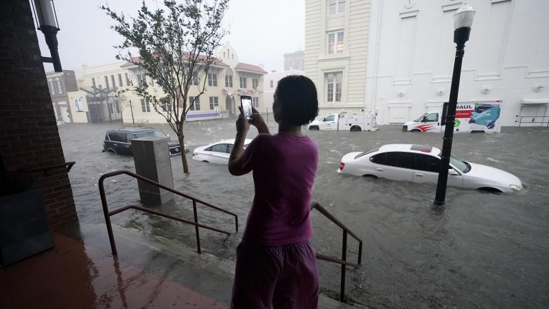 Floodwaters swamp cars on a street in downtown Pensacola, Fla., on Wednesday. Hurricane Sally made landfall near Gulf Shores, Ala., as a Category 2 storm, pushing a surge of ocean water and dumping torrential rainfall. Floodwaters swamp cars on a street in downtown Pensacola, Fla., on Wednesday. Hurricane Sally made landfall near Gulf Shores, Ala., as a Category 2 storm, pushing a surge of ocean water and dumping torrential rainfall.