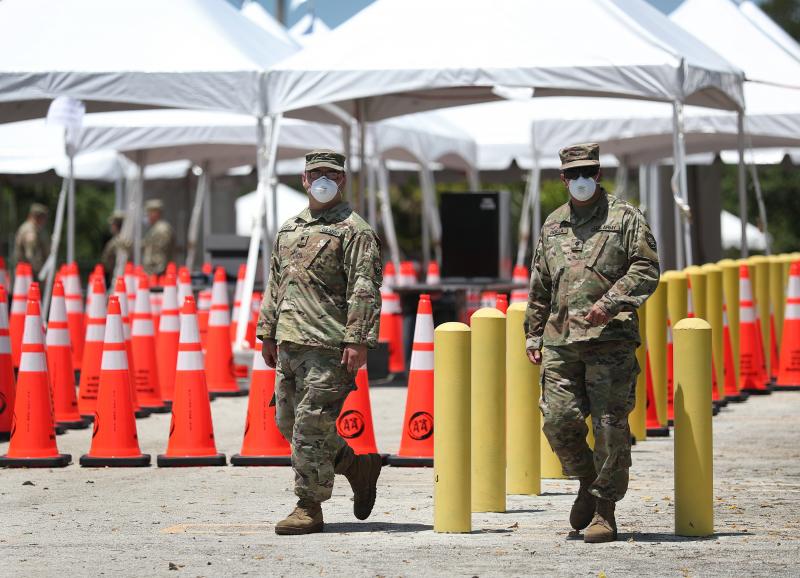 Members of the Florida National Guard are seen at a coronavirus testing site on April 27 in North Miami. Restrictions are easing, but officials worry people might now hesitate to evacuate during a hurricane. Members of the Florida National Guard are seen at a coronavirus testing site on April 27 in North Miami. Restrictions are easing, but officials worry people might now hesitate to evacuate during a hurricane.