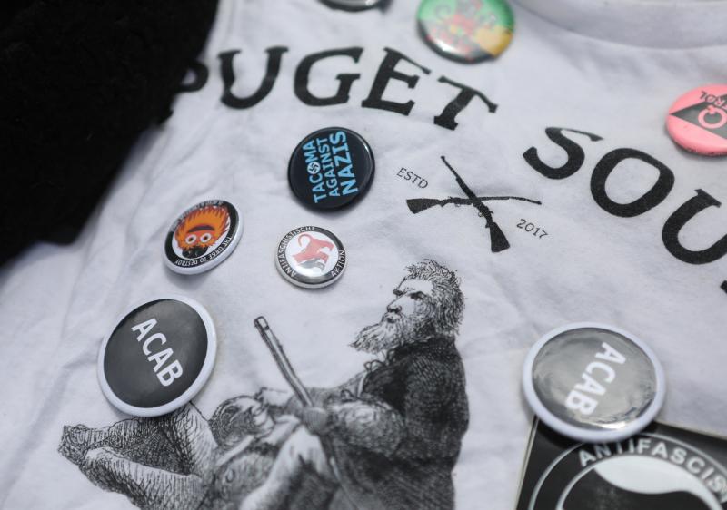 A shirt and pins that belonged to van Spronsen. He stood up to far-right leaders at local rallies, and he was a fixture at demonstrations against U.S. immigration policies, especially family separation. "Kids in cages," he called it. A shirt and pins that belonged to van Spronsen. He stood up to far-right leaders at local rallies, and he was a fixture at demonstrations against U.S. immigration policies, especially family separation. "Kids in cages," he called it.