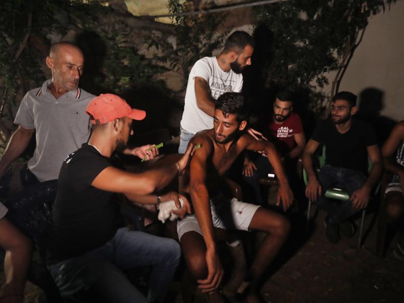 Ibrahim Lasheen, 22, is brought back to his hometown of Tripoli, Lebanon, in September. A U.N. naval force rescued him after he swam for 18 hours to seek help for dozens of fellow passengers crammed on a small fishing boat that ran out of fuel as it heade Ibrahim Lasheen, 22, is brought back to his hometown of Tripoli, Lebanon, in September. A U.N. naval force rescued him after he swam for 18 hours to seek help for dozens of fellow passengers crammed on a small fishing boat that ran out of fuel as it heade