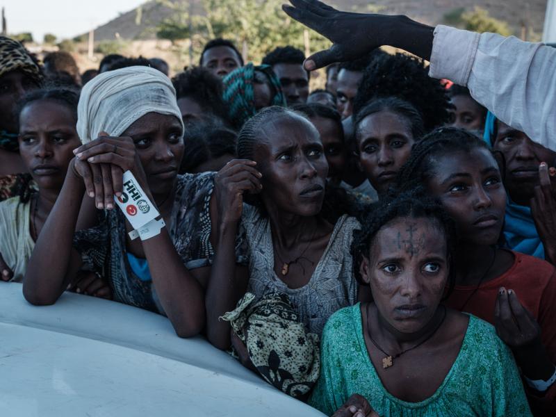 Ethiopians wait for food distribution in front of a warehouse at Um Raquba refugee camp in Gedaref, eastern Sudan, on Dec. 1. Ethiopians wait for food distribution in front of a warehouse at Um Raquba refugee camp in Gedaref, eastern Sudan, on Dec. 1.