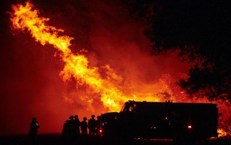 Firefighters watch as flames tower over their truck Wednesday at the Bear Fire in Oroville, Calif. The 2020 fire season is off to a staggering start, far outpacing last year. Firefighters watch as flames tower over their truck Wednesday at the Bear Fire in Oroville, Calif. The 2020 fire season is off to a staggering start, far outpacing last year.