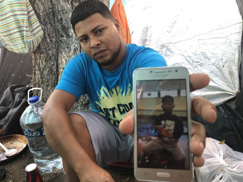 Migrant parents in the tent camps in Matamoros, Mexico, are sending their kids across the border and taking advantage of the rule that unaccompanied children can't be returned to Mexico. Here, Alexis Martinez holds a cellphone photo of his 7-year-old son Migrant parents in the tent camps in Matamoros, Mexico, are sending their kids across the border and taking advantage of the rule that unaccompanied children can't be returned to Mexico. Here, Alexis Martinez holds a cellphone photo of his 7-year-old son