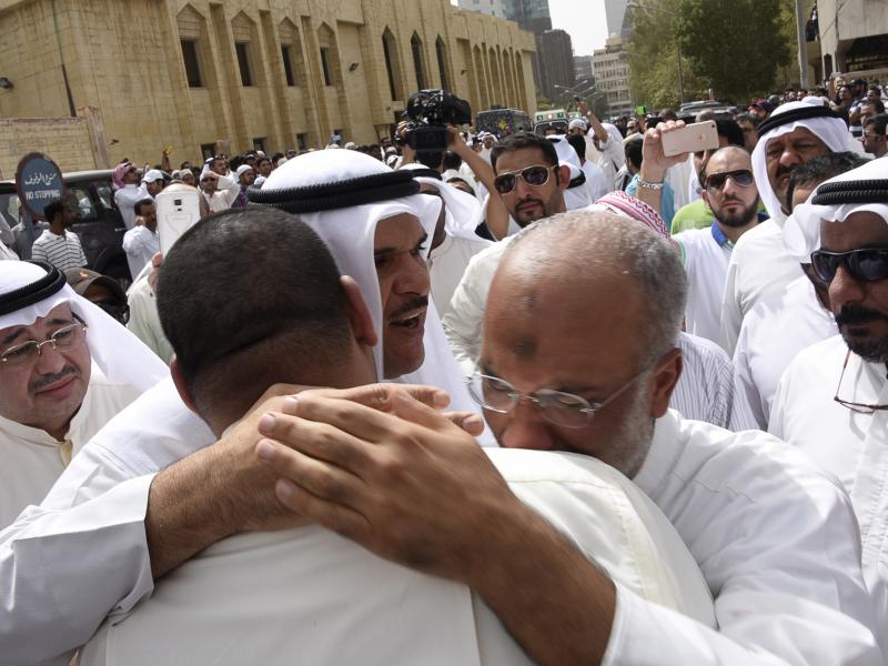 Kuwaiti Information Minister Sheikh Salman al-Humoud al-Sabah (center) consoles worshipers outside the Imam Sadiq Mosque after a suicide bomb attack following Friday prayers. Kuwaiti Information Minister Sheikh Salman al-Humoud al-Sabah (center) consoles worshipers outside the Imam Sadiq Mosque after a suicide bomb attack following Friday prayers.