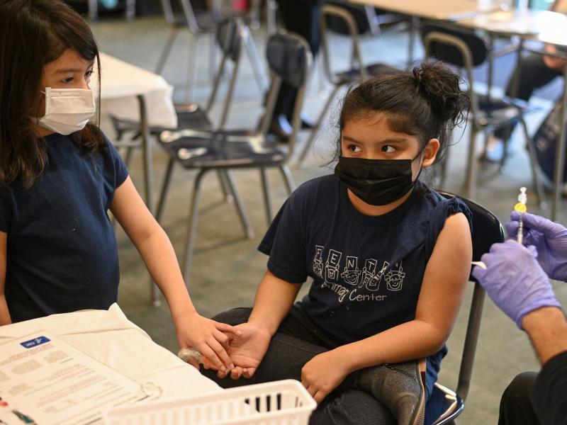 Pfizer will submit new data to the FDA this week about trials of its vaccine for kids younger than 5 years old. Here, a girl holds her sister's hand as a nurse prepares to administer the COVID-19 vaccine at a vaccination clinic in Los Angeles. Kids 5 and Pfizer will submit new data to the FDA this week about trials of its vaccine for kids younger than 5 years old. Here, a girl holds her sister's hand as a nurse prepares to administer the COVID-19 vaccine at a vaccination clinic in Los Angeles. Kids 5 and