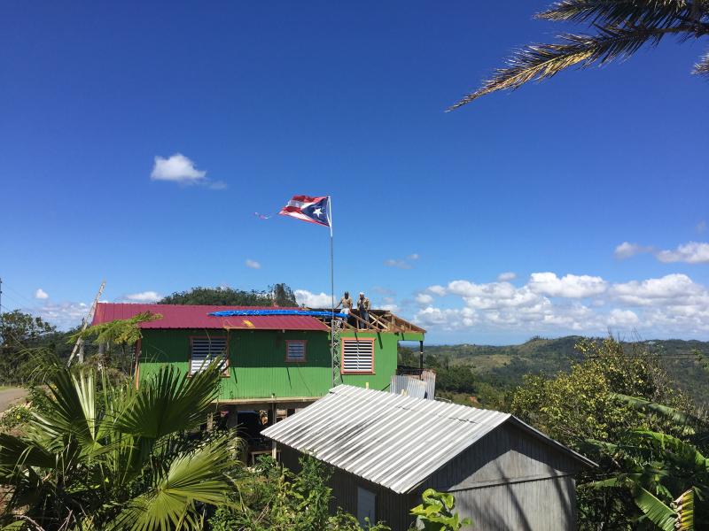 In the aftermath of Hurricane Maria, restorations are being made to a roof in Castañer, a village in Puerto Rico's central mountains. But recovery is slow. In the aftermath of Hurricane Maria, restorations are being made to a roof in Castañer, a village in Puerto Rico's central mountains. But recovery is slow.