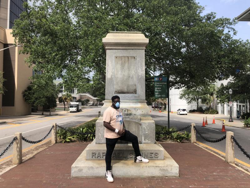 Protest organizer DAntjuan Miller stands by the granite pedestal that remains of a monument to Confederate Navy Adm. Raphael Semmes in Mobile, Ala. "It's like a weight that's lifted off now that it's gone," he says. Protest organizer DAntjuan Miller stands by the granite pedestal that remains of a monument to Confederate Navy Adm. Raphael Semmes in Mobile, Ala. "It's like a weight that's lifted off now that it's gone," he says.