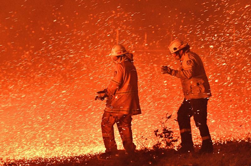 On December 31, 2019 firefighters struggled against the strong wind in an effort to secure nearby houses from bushfires near the town of Nowra in the Australian state of New South Wales. On December 31, 2019 firefighters struggled against the strong wind in an effort to secure nearby houses from bushfires near the town of Nowra in the Australian state of New South Wales.