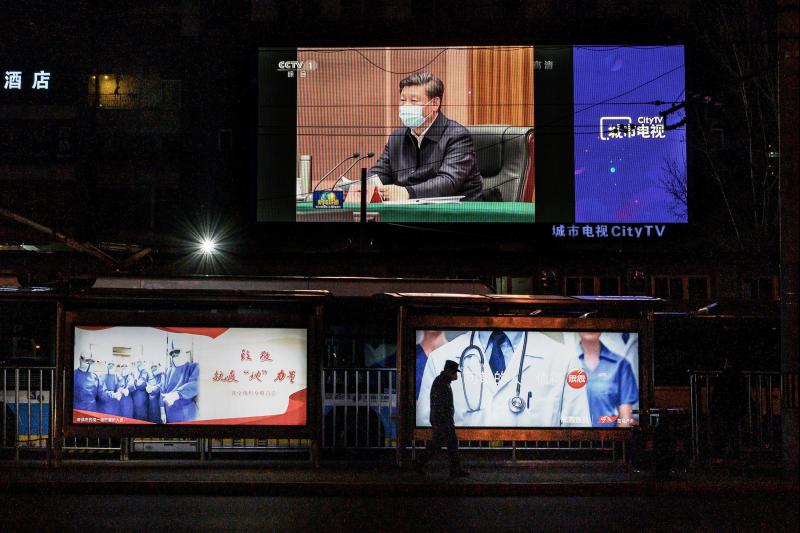 A large screen broadcasting an evening newscast along a Beijing street in March shows Chinese President Xi Jinping wearing a protective mask during his visit to Wuhan earlier in the day. A large screen broadcasting an evening newscast along a Beijing street in March shows Chinese President Xi Jinping wearing a protective mask during his visit to Wuhan earlier in the day.