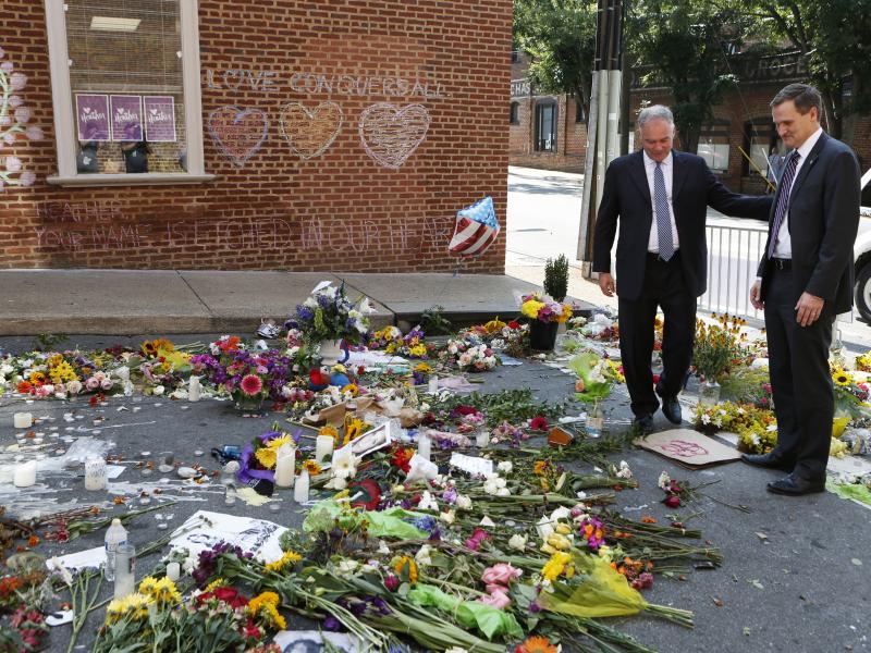 Sen. Tim Kaine, left, and then-Charlottesville mayor Michael Signer visit a temporary memorial Wednesday, Aug. 16, 2017, where Heather Heyer was killed when a car rammed into a crowd of people protesting a white nationalist rally Charlottesville, Va. Sen. Tim Kaine, left, and then-Charlottesville mayor Michael Signer visit a temporary memorial Wednesday, Aug. 16, 2017, where Heather Heyer was killed when a car rammed into a crowd of people protesting a white nationalist rally Charlottesville, Va.