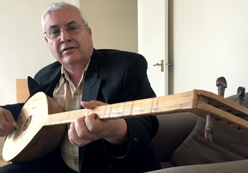 Khoshaba Jaber, an Assyrian living in West London, plays a tambura, a traditional instrument known as the "mother of strings," after singing an epic poem he learned in his boyhood village in northern Iraq. Khoshaba Jaber, an Assyrian living in West London, plays a tambura, a traditional instrument known as the "mother of strings," after singing an epic poem he learned in his boyhood village in northern Iraq.