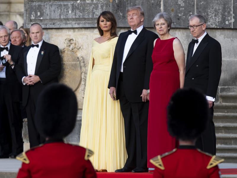 U.S. first lady Melania Trump, President Trump, British Prime Minister Theresa May and her husband, Philip May, watch a military performance ahead of a dinner in Oxfordshire, U.K., on Thursday. U.S. first lady Melania Trump, President Trump, British Prime Minister Theresa May and her husband, Philip May, watch a military performance ahead of a dinner in Oxfordshire, U.K., on Thursday.