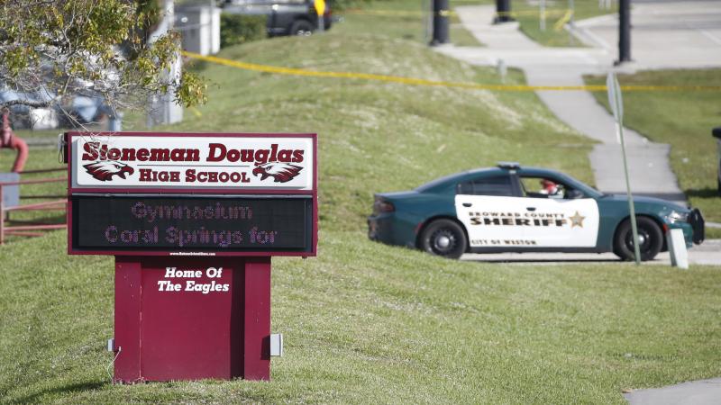 Law enforcement officers block off the entrance to Marjory Stoneman Douglas High School on Feb. 15 in Parkland, Fla. A day earlier a gunman opened fire in the school. Law enforcement officers block off the entrance to Marjory Stoneman Douglas High School on Feb. 15 in Parkland, Fla. A day earlier a gunman opened fire in the school.
