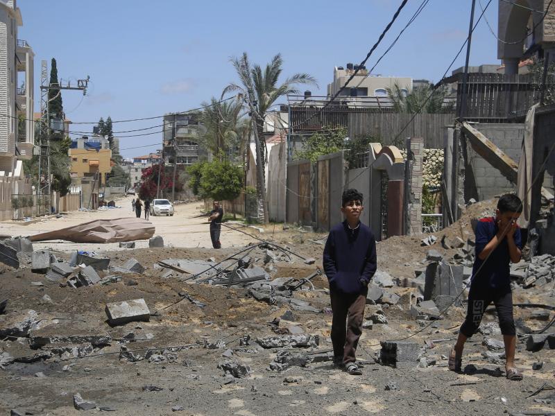 Palestinian children walk past the rubble of a house hit by Israeli airstrikes this week in Beit Lahyia in the northern Gaza Strip. Palestinian children walk past the rubble of a house hit by Israeli airstrikes this week in Beit Lahyia in the northern Gaza Strip.
