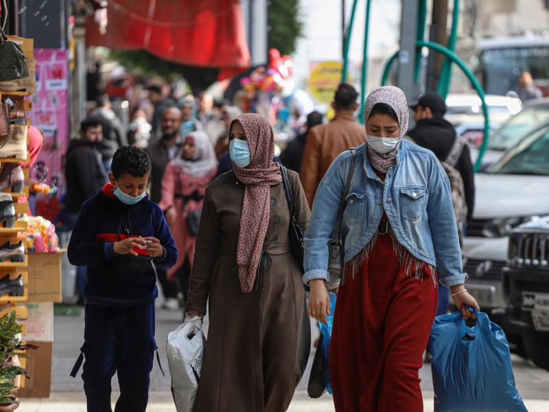 People wear face masks on a shopping street in Gaza City in January. People wear face masks on a shopping street in Gaza City in January.