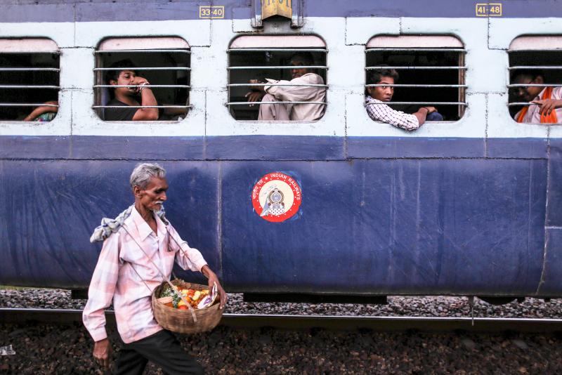 Train journeys in India were once defined by food, brought by passengers from their homes and purchased from vendors like this one. Passengers shared food with each other, exchanging stories and family histories, and sometimes striking new friendships th Train journeys in India were once defined by food, brought by passengers from their homes and purchased from vendors like this one. Passengers shared food with each other, exchanging stories and family histories, and sometimes striking new friendships th