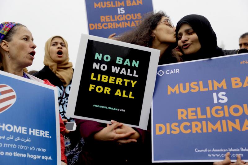 Deeba Jafri gives Hena Zuberi a kiss as they protest in front of Supreme Court on Wednesday as the court heard arguments over the Trump Administration's travel ban. Deeba Jafri gives Hena Zuberi a kiss as they protest in front of Supreme Court on Wednesday as the court heard arguments over the Trump Administration's travel ban.