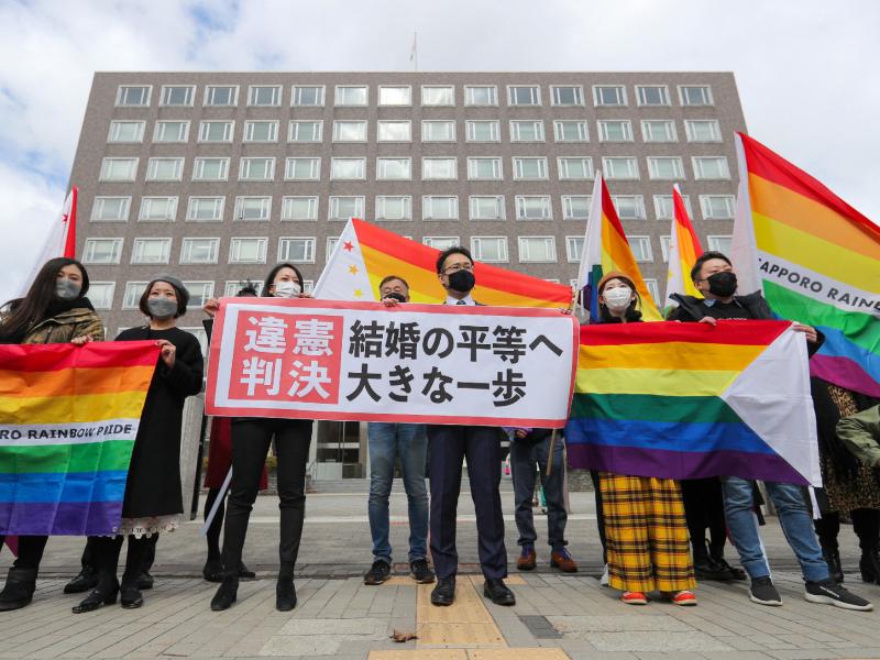 Supporters celebrate the district court's ruling on Japan's same-sex marriage ban with a flag reading "unconstitutional decision" in Sapporo, Hokkaido prefecture, on Wednesday. Supporters celebrate the district court's ruling on Japan's same-sex marriage ban with a flag reading "unconstitutional decision" in Sapporo, Hokkaido prefecture, on Wednesday.
