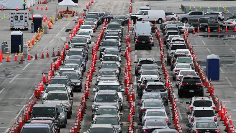 Lines and lines of cars are seen as drivers wait on Monday to be tested for COVID-19 at a coronavirus testing site in Miami Gardens, Fla. Lines and lines of cars are seen as drivers wait on Monday to be tested for COVID-19 at a coronavirus testing site in Miami Gardens, Fla.