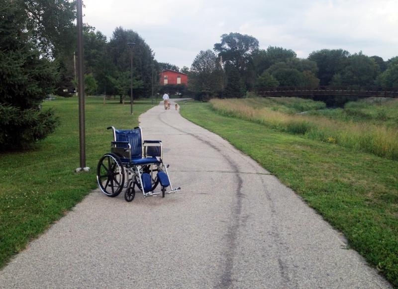 A lone Mayo Clinic wheelchair sits on the Cascade Creek walking trail near Kutzky Park in Rochester, Minn. A lone Mayo Clinic wheelchair sits on the Cascade Creek walking trail near Kutzky Park in Rochester, Minn.