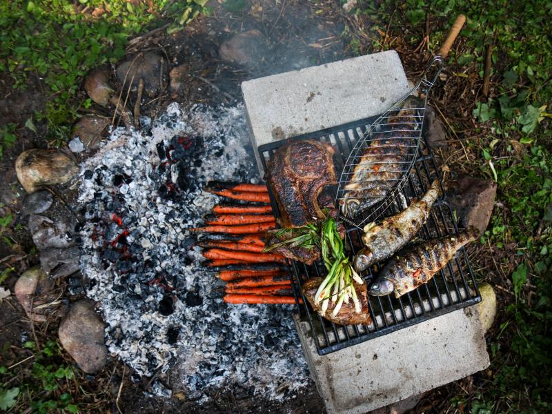 Rainbow trout on a grill. Yia Vang says that food played a central role in his home — his mother grew vegetables and his father cooked meat over a fire pit in the backyard. Rainbow trout on a grill. Yia Vang says that food played a central role in his home — his mother grew vegetables and his father cooked meat over a fire pit in the backyard.