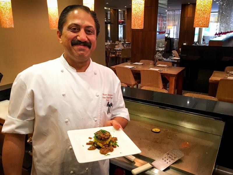 Rasika chef Vikram Sunderam, here with a towering dish of eggplant and potato, says, "Indian cuisine is a very personal cuisine. It's made from family to family, how they like to cook." Rasika chef Vikram Sunderam, here with a towering dish of eggplant and potato, says, "Indian cuisine is a very personal cuisine. It's made from family to family, how they like to cook."