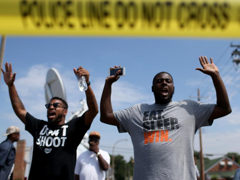 The shooting of Michael Brown in Ferguson, Mo., also led to a series of protests. Many of them, like this protest on Aug. 19, featured people raising their arms and chanting, "Hands up, don't shoot." But interactions between police and protesters were mor The shooting of Michael Brown in Ferguson, Mo., also led to a series of protests. Many of them, like this protest on Aug. 19, featured people raising their arms and chanting, "Hands up, don't shoot." But interactions between police and protesters were mor