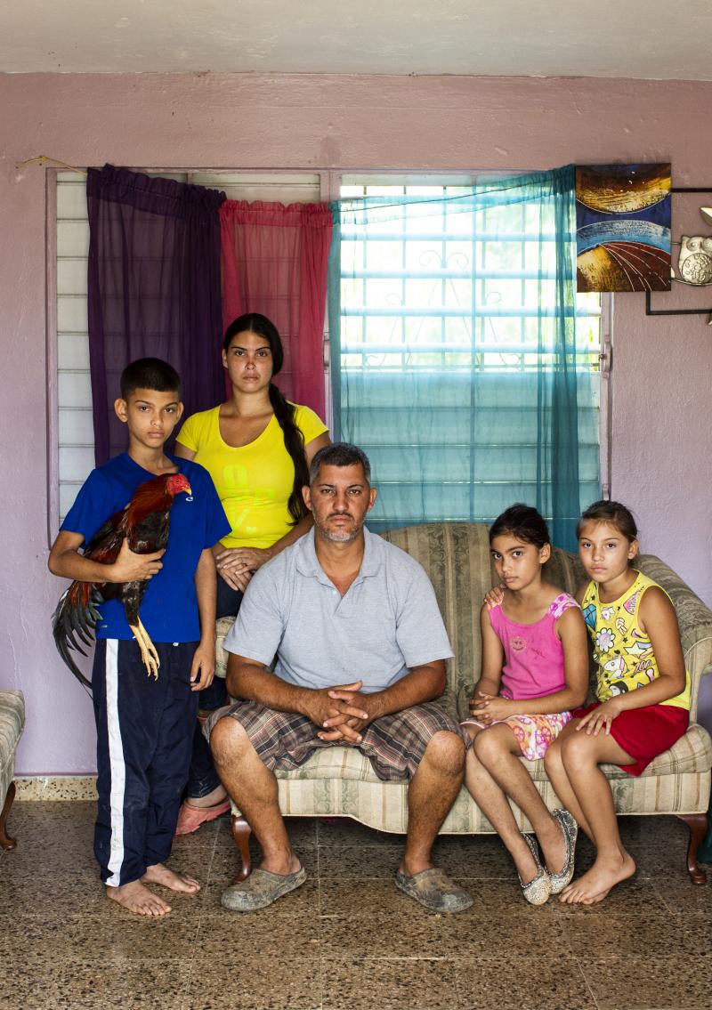 From left, José Yadiel Torres, 10, Lizmary Rivera, 29, José Torres, 38, and twins Janniela and Jamiléth Torres, 9, pose for a family portrait in their house in Utuado. The rooster, the family's most prized bird, is named Matatoro. From left, José Yadiel Torres, 10, Lizmary Rivera, 29, José Torres, 38, and twins Janniela and Jamiléth Torres, 9, pose for a family portrait in their house in Utuado. The rooster, the family's most prized bird, is named Matatoro.