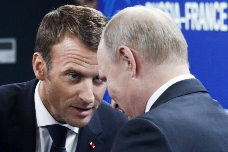 French President Emmanuel Macron (left) and Russian President Vladimir Putin attend a meeting with Russian and French business people during the St. Petersburg International Economic Forum on Friday. French President Emmanuel Macron (left) and Russian President Vladimir Putin attend a meeting with Russian and French business people during the St. Petersburg International Economic Forum on Friday.