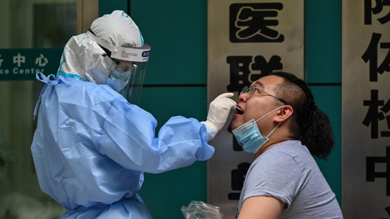 A man gets tested for the coronavirus Wednesday in Wuhan, China, the cradle of the global pandemic. Authorities plan to test the city's entire population after new cases emerged for the first time in weeks, according to state media. A man gets tested for the coronavirus Wednesday in Wuhan, China, the cradle of the global pandemic. Authorities plan to test the city's entire population after new cases emerged for the first time in weeks, according to state media.