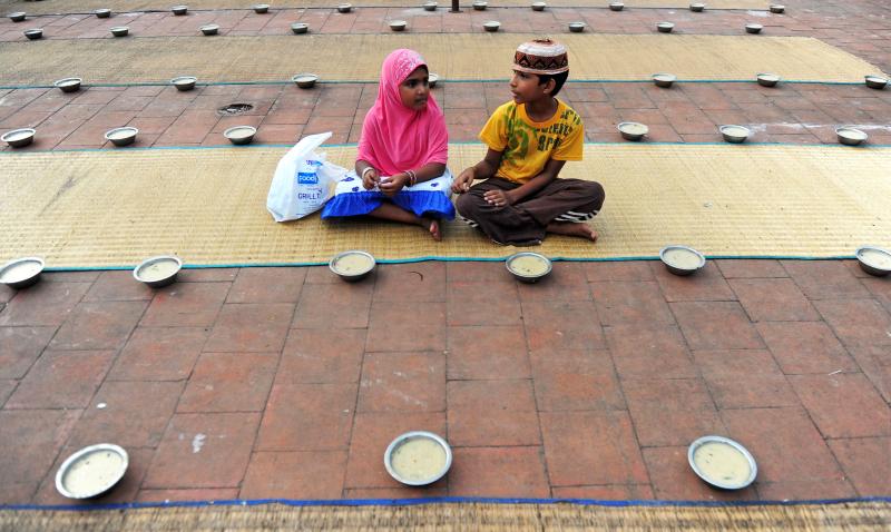 Young Indian children sit with bowls of porridge (nombu kanji) as they prepare to break the fast with the Iftar meal during the Islamic month of Ramadan at The Wallajah Big Mosque in Chennai last July. Young Indian children sit with bowls of porridge (nombu kanji) as they prepare to break the fast with the Iftar meal during the Islamic month of Ramadan at The Wallajah Big Mosque in Chennai last July.