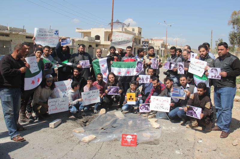 Syrian residents of Khan Shaykhun hold signs and pictures on Friday during a protest condemning a suspected chemical weapons attack on their town earlier this week. Syrian residents of Khan Shaykhun hold signs and pictures on Friday during a protest condemning a suspected chemical weapons attack on their town earlier this week.