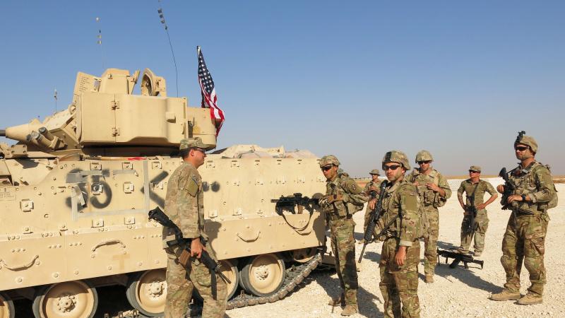 A new U.S. brigade combat team arrives in front of a Bradley Fighting Vehicle at a base in Syria's Hasakah province. A new U.S. brigade combat team arrives in front of a Bradley Fighting Vehicle at a base in Syria's Hasakah province.