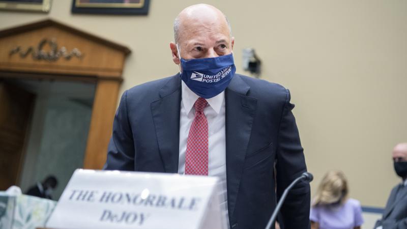 Postmaster General Louis DeJoy arrives to testify during a House Oversight and Reform Committee hearing in August. Postmaster General Louis DeJoy arrives to testify during a House Oversight and Reform Committee hearing in August.