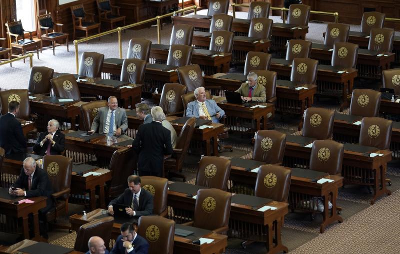 Empty seats are seen in the House Chamber at the Texas Capitol, Tuesday, July 13, 2021, in Austin, Texas. Texas Democrats left the state to block sweeping new election laws, while Republican Gov. Greg Abbott threatened them with arrest the moment they ret Empty seats are seen in the House Chamber at the Texas Capitol, Tuesday, July 13, 2021, in Austin, Texas. Texas Democrats left the state to block sweeping new election laws, while Republican Gov. Greg Abbott threatened them with arrest the moment they ret