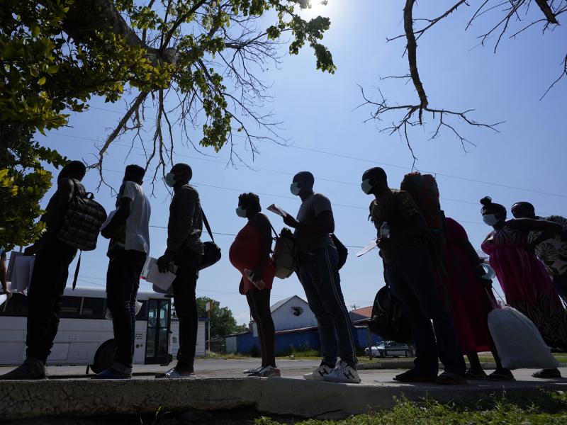 Migrants stand in line at a respite center in June after they crossed the U.S.-Mexico border and turned themselves in and were released in Del Rio, Texas. Migrants stand in line at a respite center in June after they crossed the U.S.-Mexico border and turned themselves in and were released in Del Rio, Texas.