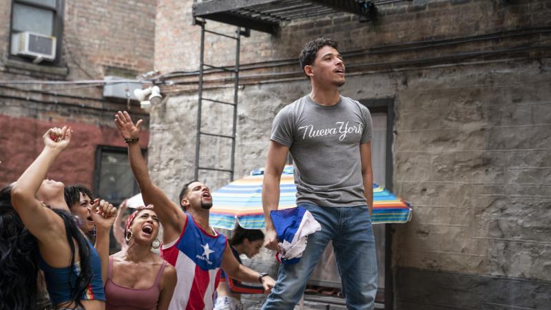 Usnavi (Anthony Ramos) runs a corner bodega and dreams of returning to the Dominican Republic in In the Heights. Usnavi (Anthony Ramos) runs a corner bodega and dreams of returning to the Dominican Republic in In the Heights.
